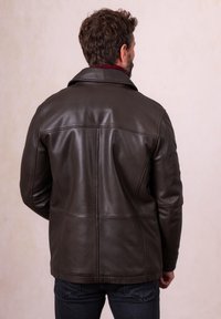 Dark brown leather jacket with a structured design, featuring a notched collar and smooth texture, shown from the back.