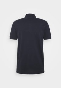 Polo bleu marine à manches courtes en tissu doux, avec un col classique et des poignets côtelés, doté d'un dos uni.