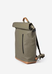 Olive green roll-top backpack with a tan bottom, black zipper pocket, adjustable straps, and a textured, water-resistant material.