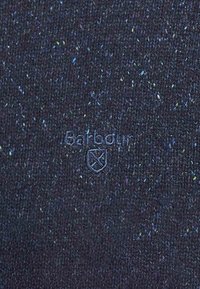 Dark navy knit sweater with a textured surface, featuring specks of color and an embroidered "Barbour" logo on the front.