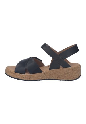 Zwarte lederen sandalen met gekruiste bandjes, een kurken sleehakzool en een gladde, lichte binnenzool. Voorzien van een rubberen buitenzool voor grip.