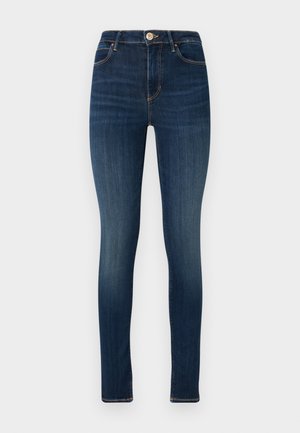 Dunkelblaue Skinny Jeans aus Denim, mit einer Frontknopfverschlüsse, fünf Taschen Design und subtiler Ausbleichung an den Oberschenkeln.