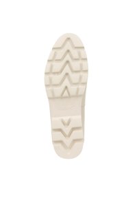 Witte rubberen schoenzool met een zigzagloopvlak en de merknaam "VIONIC" in het midden geperst. Gladde en duurzame oppervlakte.