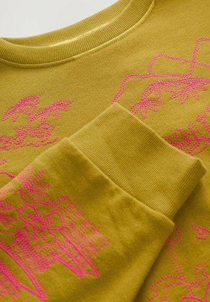 Olive green sweatshirt featuring vibrant pink embroidery of floral and architectural patterns, with ribbed neckline and cuffs.