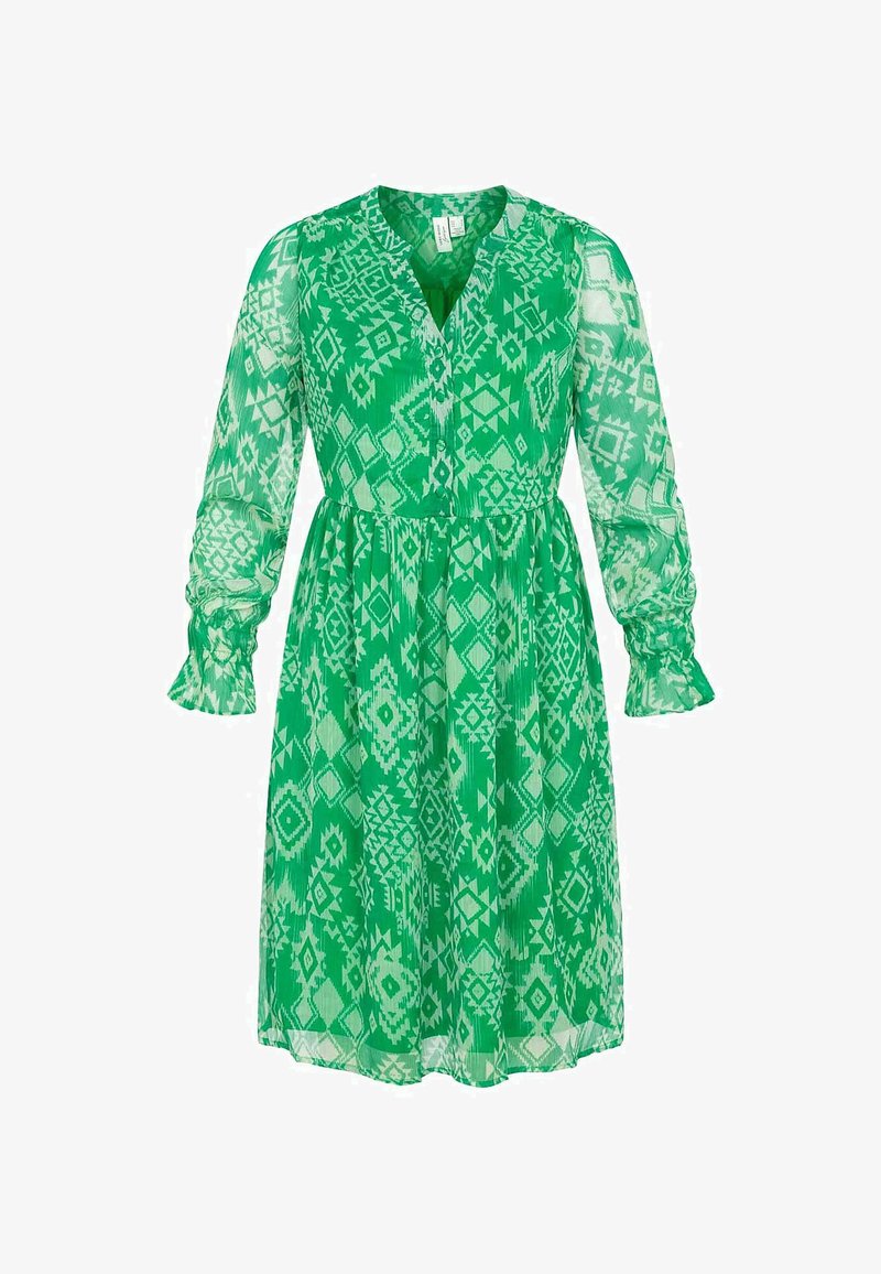 Grön, genomskinlig klänning med v-ringning, långa puffärmar och elastiska manschetter. Har ett geometriskt mönster och en insydd midja.