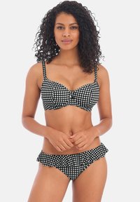 Conjunto de bikini a cuadros en blanco y negro que incluye un sujetador con relleno, tirantes ajustables y bordes con volantes en la parte inferior del bikini. Textura de tela suave.