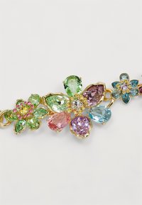 Colorful floral brooch featuring various-shaped gems in green, pink, purple, and blue, set in goldtone metal with decorative accents.