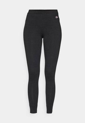 Black fitted leggings with elastic waistband, featuring a small Champion logo on the upper left hip.
