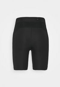 Shorts de sport noirs avec une taille haute et une petite poche zippée à l'arrière, conçus pour un ajustement cintré.
