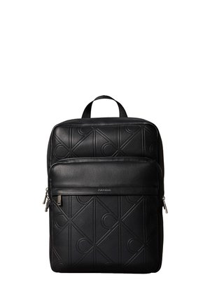 Black leather backpack with embossed geometric pattern, front zip pocket, top handle, and silver zipper pulls.