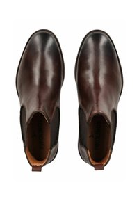 Botines de cuero marrón oscuro con paneles laterales elásticos, punta redondeada y acentos texturizados. Presentan una tira en la parte trasera para facilitar el calzado.