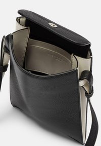 Black leather shoulder bag with a textured exterior, light cream interior, and a magnetic snap closure. Features an adjustable strap.