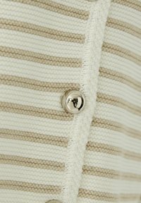 Striped cardigan in cream and beige knit. Features a smooth texture and metallic button detail along the opening.