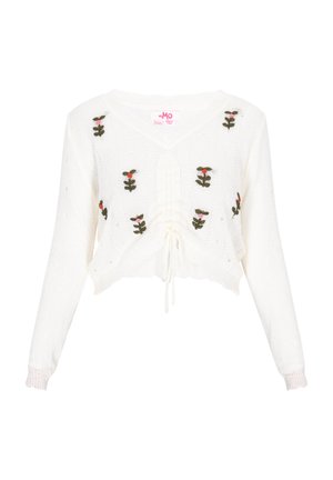 Trumpas baltas megztas svarkas su žiedų aplikacijomis žalia, rožine ir raudona spalvomis. Yra V formos iškirptė, raištelio juosmuo ir sutrauktos rankogaliai.