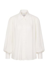 Blouse blanche à manches longues avec manches bouffantes, boutonnée sur le devant, col pointu et poignets ajustés.