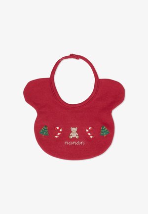 Bavaglino rosso in cotone con ricami di un orsetto, alberi di Natale verdi e bastoncini di zucchero, con la scritta "nanan" ricamata sotto.