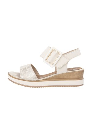 Beige wedge sandals with a textured front strap, a wide ankle strap featuring a gold rectangular buckle, and a cork-like heel.