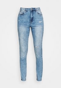 Jean skinny taille haute bleu clair en denim, avec des détails usés et une coupe ajustée.