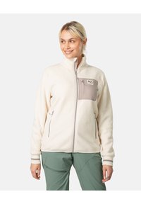 Fleecejakke i kremfarge med glidelås brystlomme og kontrasterende beige detaljer; har høy hals og sidelommer.