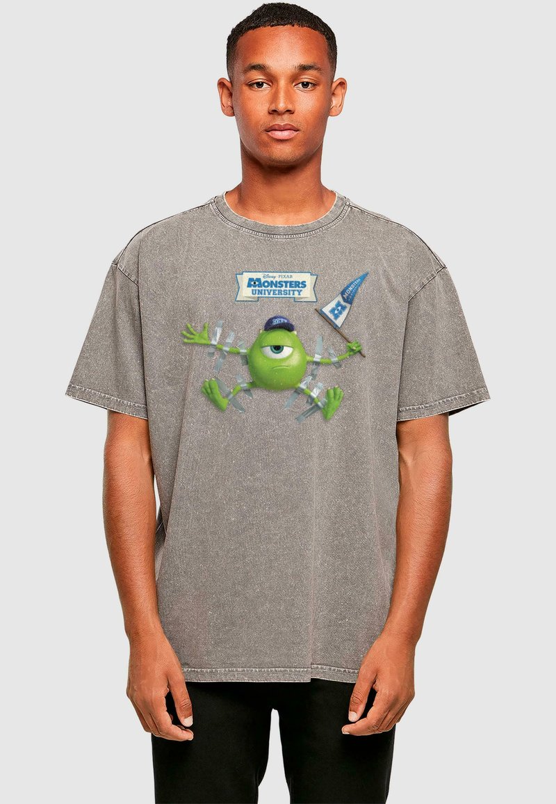 Graues, übergroßes T-Shirt mit einem Grafikdruck eines grünen Monsters mit einem Auge, umgeben von einer blauen Flagge und dem Text "Monsters University."