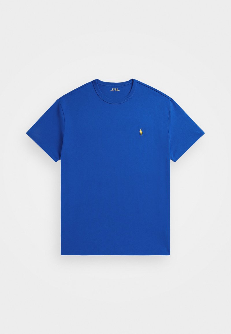 Kuninglik sinine puuvillane T-särk, ümmarguse kaelusega, lühikeste varrukatega ja vasakul rinnal väikese kollase tikandiga logoga. Minimalistlik disain.