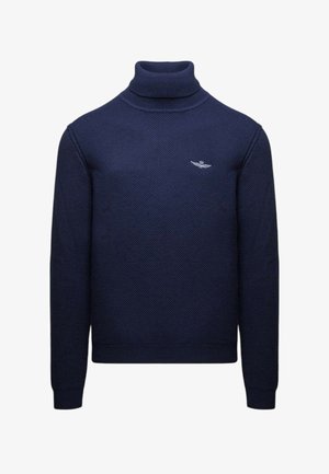 Maglione a collo alto color navy in tessuto strutturato con maniche lunghe. Presenta un piccolo logo argentato sul petto. Vestibilità classica e polsini a costine.