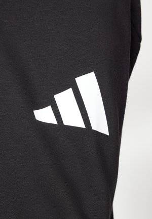 Black fabric with a smooth texture featuring a prominent white three-stripe logo. The design consists of three ascending shapes.