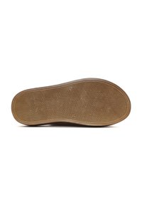 Rubber shoe sole with a textured pattern, featuring a rounded edge and a brown hue. Markings include sizes and a small logo imprint.