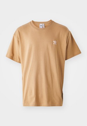Brown cotton t-shirt with a crew neck and short sleeves. Features a small white Adidas logo on the left chest. Soft texture, relaxed fit.