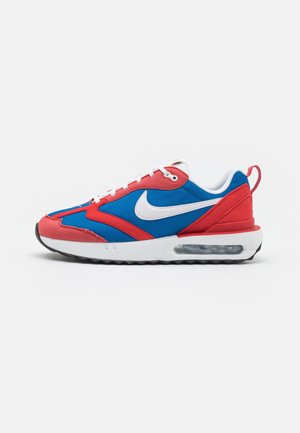 Nike Air Max sneaker in blue and red with white swoosh logo, laces, and visible air cushion in the sole, side view on a white background.