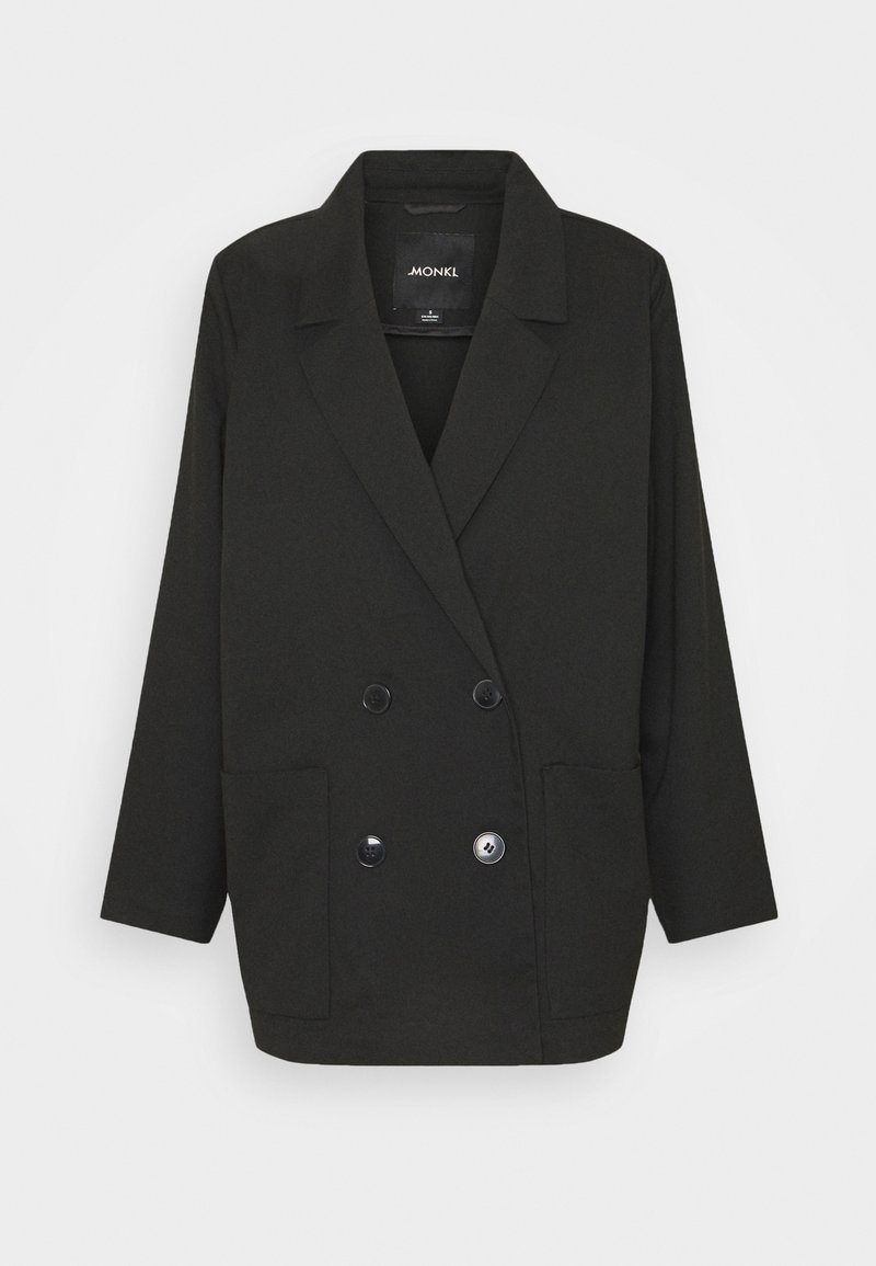 Černý oversized dvouřadý blejzr se širokými klopami, dvěma předními kapsami a čtyřmi knoflíky, vystavený na světlém pozadí.