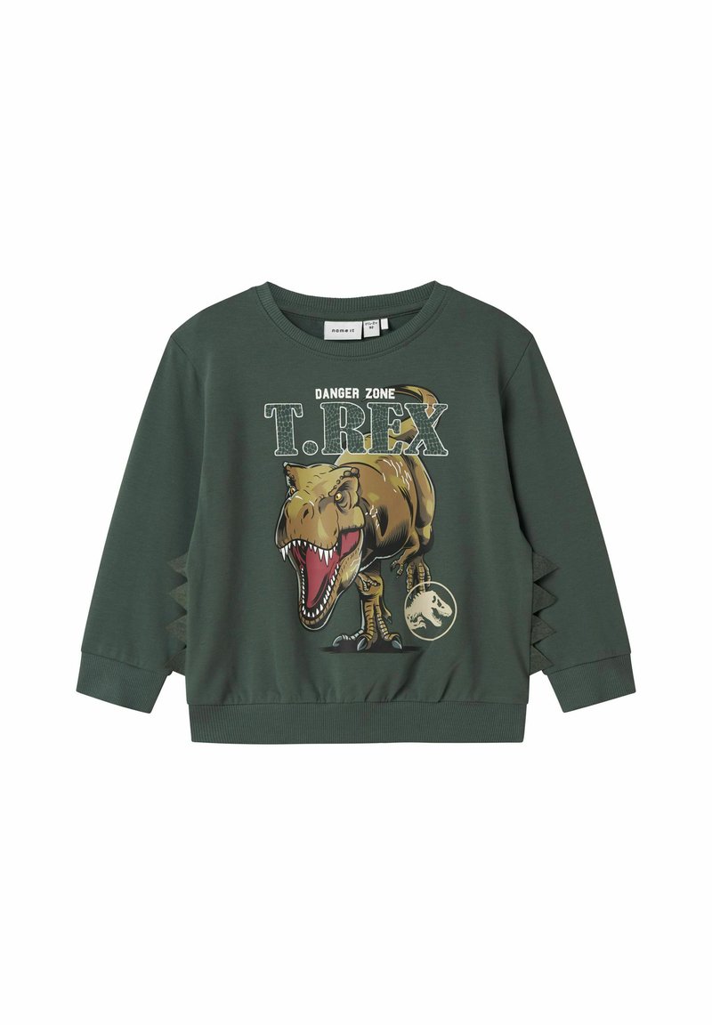 Felpa verde con grafica di T. Rex, con testo "DANGER ZONE". Polsini e orlo a costine. Tagli laterali con design a zigzag per un tocco di dettaglio.