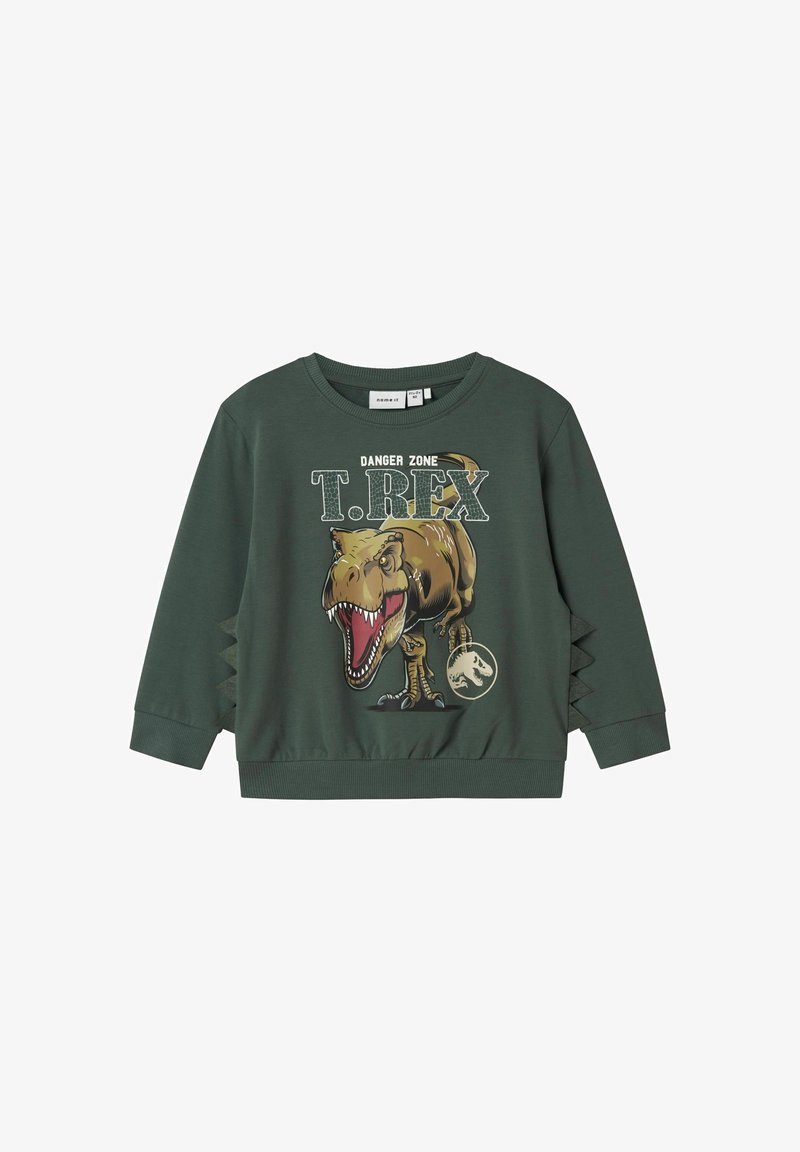 Zelená mikina se grafikou T. Rexe, obsahující text "DANGER ZONE". Hladké manžety a lem. Boční výřezy s jagged designem pro přidaný detail.