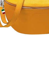 Round yellow leather bag with a textured surface, featuring a zip closure and an adjustable strap. Includes a small Italian flag charm.