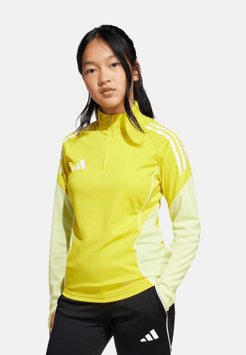 Geel sporttop met kwart-rits kraag, lange mouwen in een lichter geel, witte accenten en een aansluitend ontwerp. Zwarte broek met logodetail.