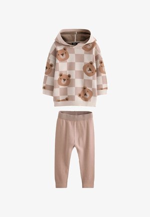 Pamučna dukserica s kapuljačom s bež i svijetlosmešastim uzorkom medvjeda, u kombinaciji s jednobojnim svijetlosmešastim tajicama. Mekani pleteni materijal, opušteni kroj.