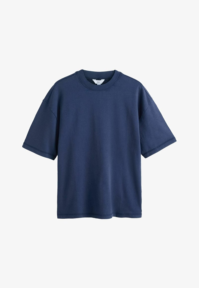 T-shirt oversize à manches courtes bleu marine avec col rond et étiquette visible à l'intérieur du col, présenté sur fond blanc.
