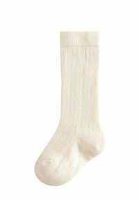 Cremfarbene gerippte Socke mit verstärkter Zehen- und Bündchenpartie. Der Baumwoll-Mix sorgt für eine weiche Textur und einen bequemen Sitz.