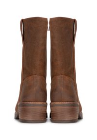 Brown leather ankle boots with a smooth texture, tapered shape, and two side zippers. Features a stacked wooden heel with horizontal grooves.