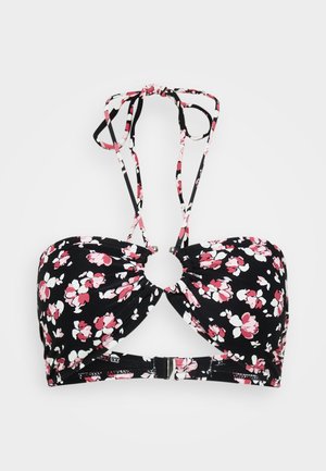 Haut de bikini noir avec un motif floral rose et blanc, présentant un détail central en anneau, des bretelles ajustables et une fermeture à clip au dos.