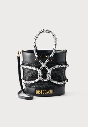 Black bucket bag with woven texture, white and black snake-patterned rope handles, gold "Just Cavalli" logo, and detachable shoulder strap.