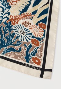 Square silk scarf featuring a floral and foliage pattern in deep blue, rust, cream, and brown, bordered with a black line and branded "Coccinelle."