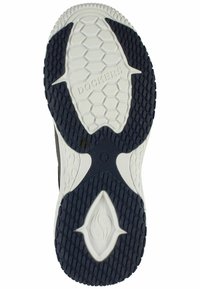 Suela de zapatilla Dockers en blanco y azul marino, con una superficie de goma texturizada que presenta patrones hexagonales y un detalle central del logo.