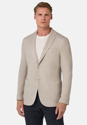 Beige blazer in a lightweight fabric, featuring two buttons, flap pockets, and notch lapels. Smooth texture with subtle weave detail.