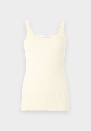 Ribbed light yellow camisole featuring adjustable lace-trimmed straps and a fitted silhouette. Soft texture with a smooth finish.