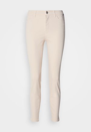 Light beige fitted jeans with a smooth texture, featuring a zip fly, button closure, and classic five-pocket design.