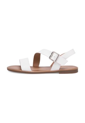 White flat sandal with two straps, a silver buckle on the ankle strap, and a tan footbed with a brown sole.