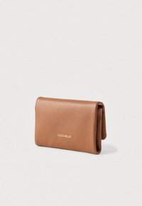 Brown textured leather wallet with "COCCINELLE" logo embossed in gold on the front, shown closed against a white background.
