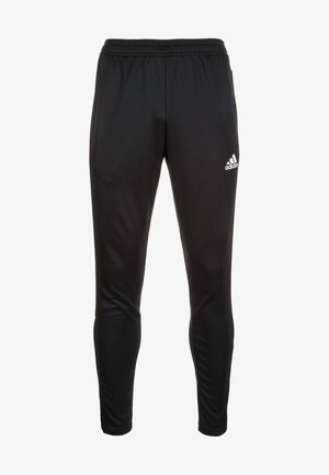 Pantalons de sport noirs avec une texture lisse, une taille élastique et un petit logo Adidas blanc sur la cuisse gauche.