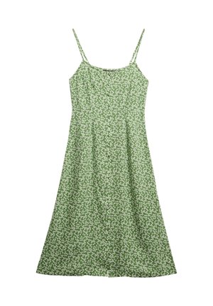 Robe verte avec des bretelles fines, ornée d'un motif floral de marguerites blanches, avec un buste ajusté et une jupe évasée, fabriquée en tissu léger.